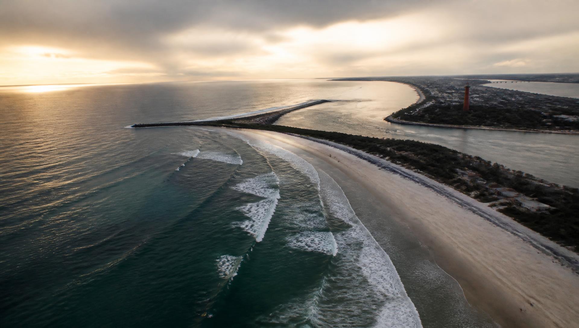 Aerial view of Ponce de Leon Inlet and the New Smyrna Beach surf line at dusk